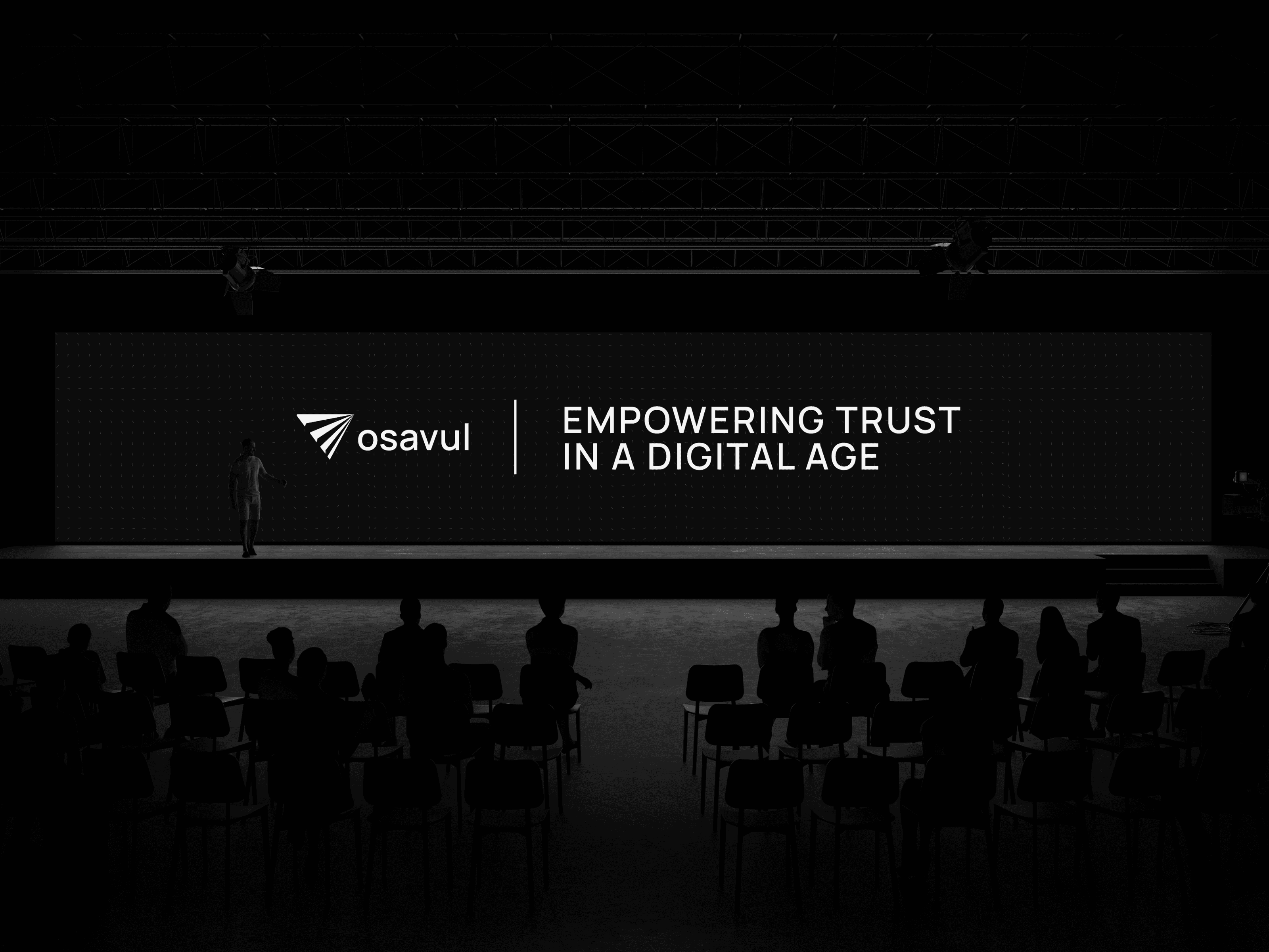 Велика сцена з темним фоном: на широкому екрані логотип Osavul і слоган «Empowering Trust in a Digital Age», на передньому плані глядачі.