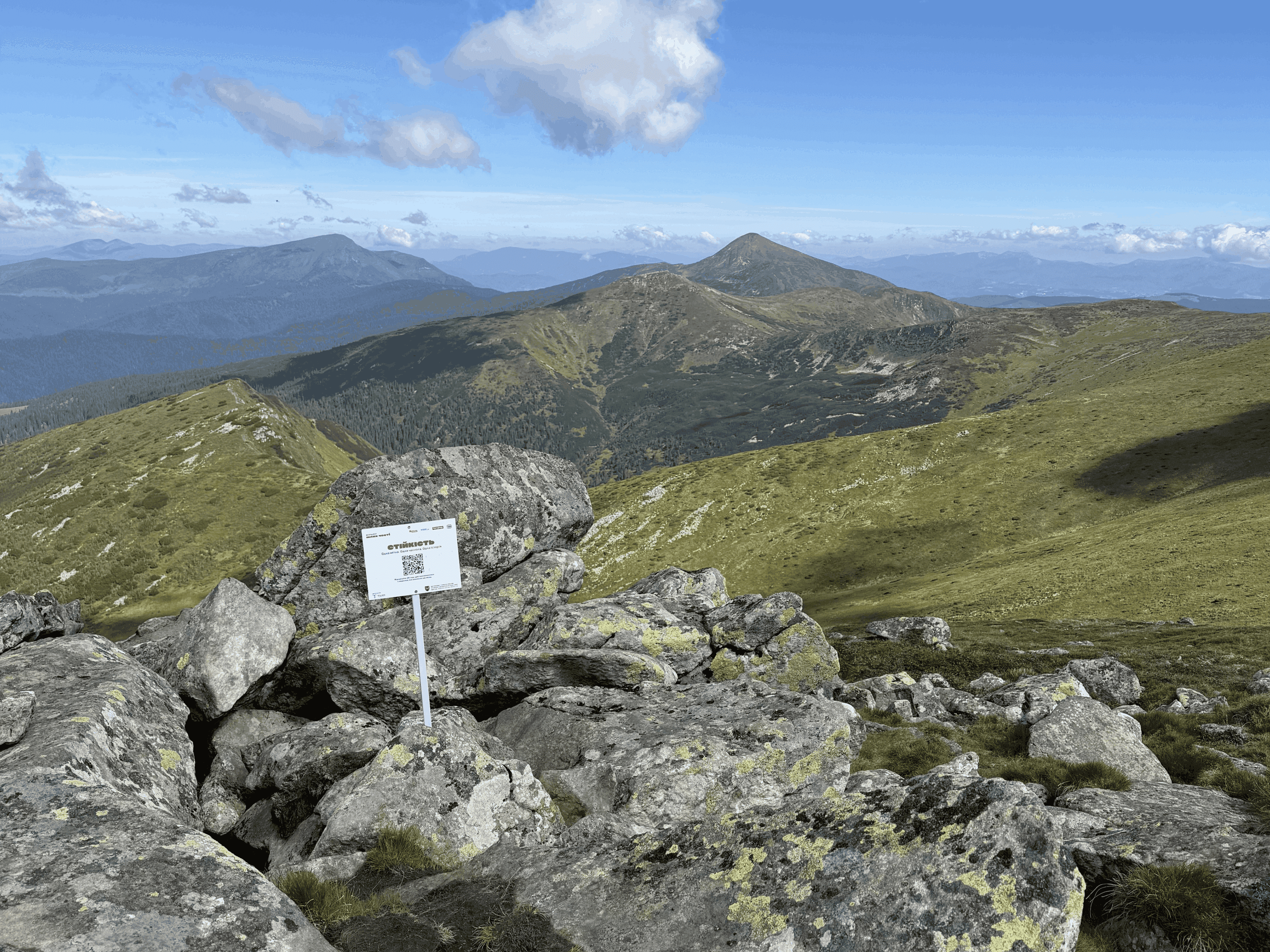 Physical QR marker for the virtue Resilience on the Chornohora ridge, with mountain peaks in the background